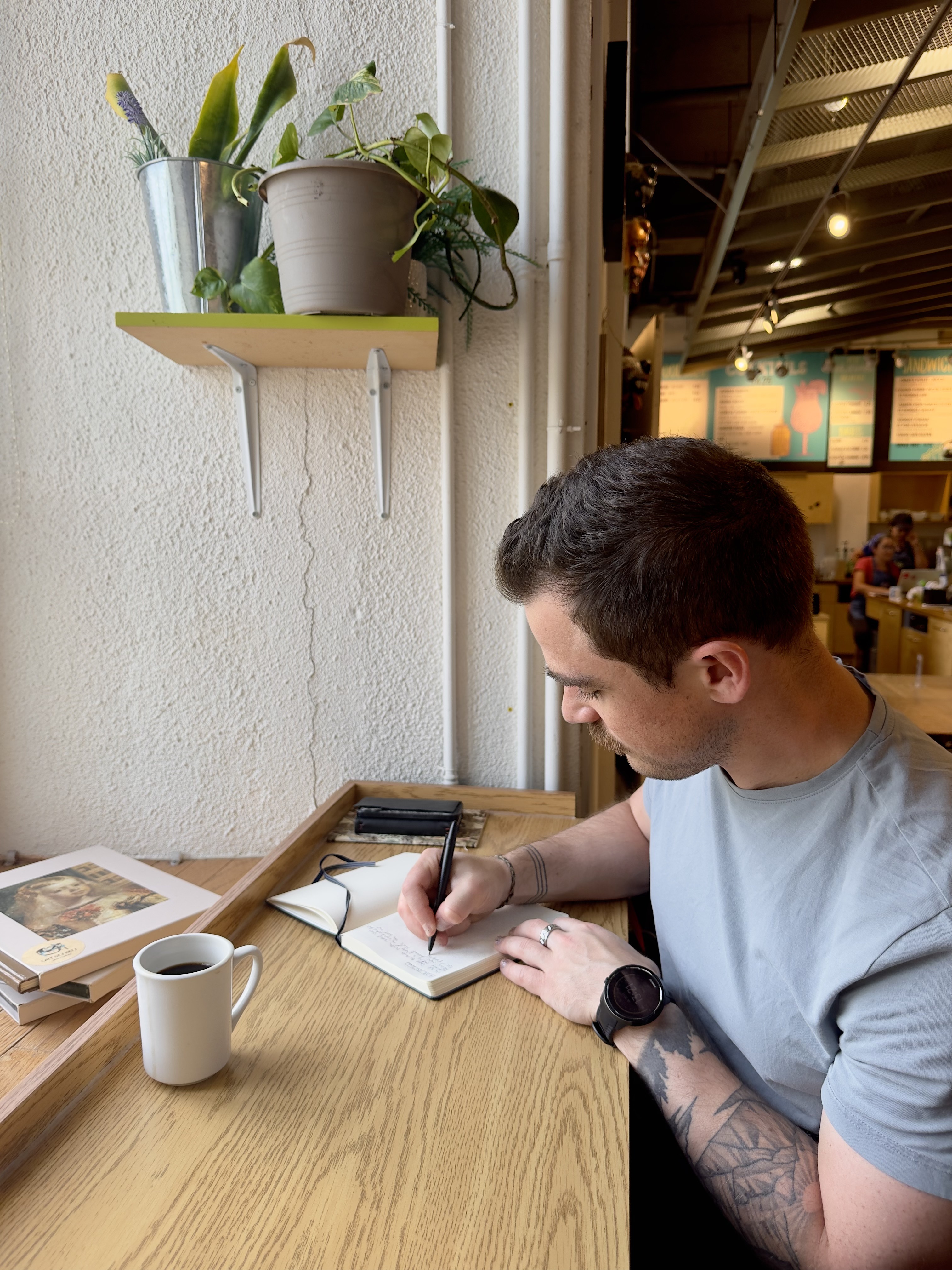 A photo of Derek MacDonald from Unobstructed writing in a journal